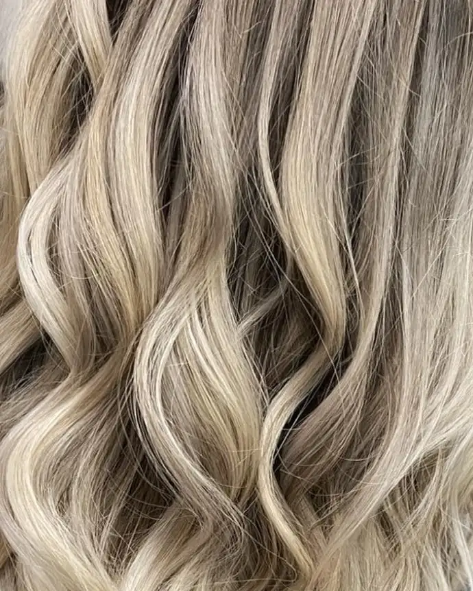 After: bright dimensional blonde in long curls