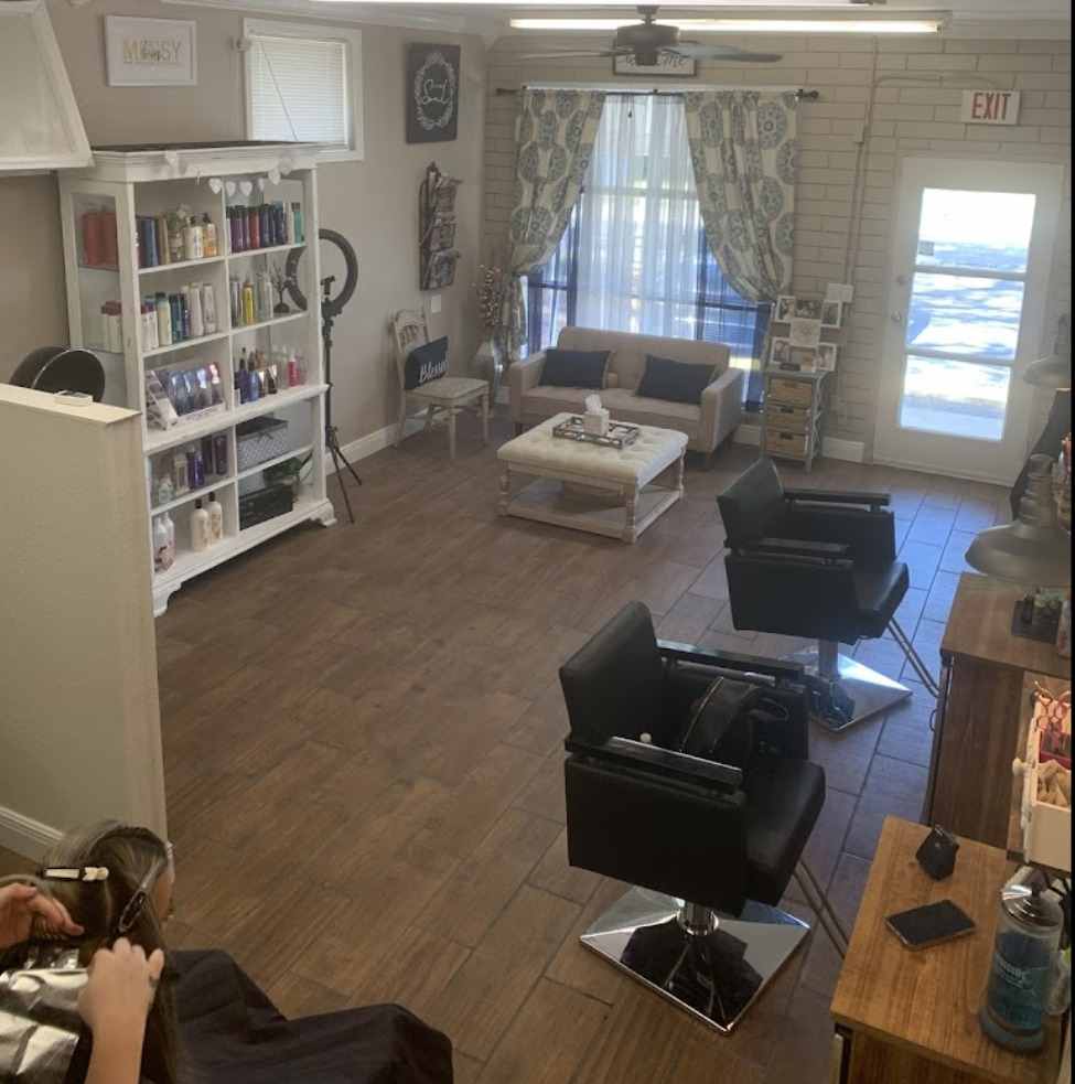 Inside Beauty Boss Hair Studio in Lakeland: styling chairs, product shelves and a bright seating area