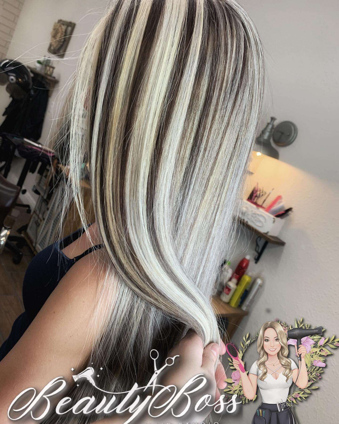 Bold platinum foil highlights against a dark brunette base on straight hair