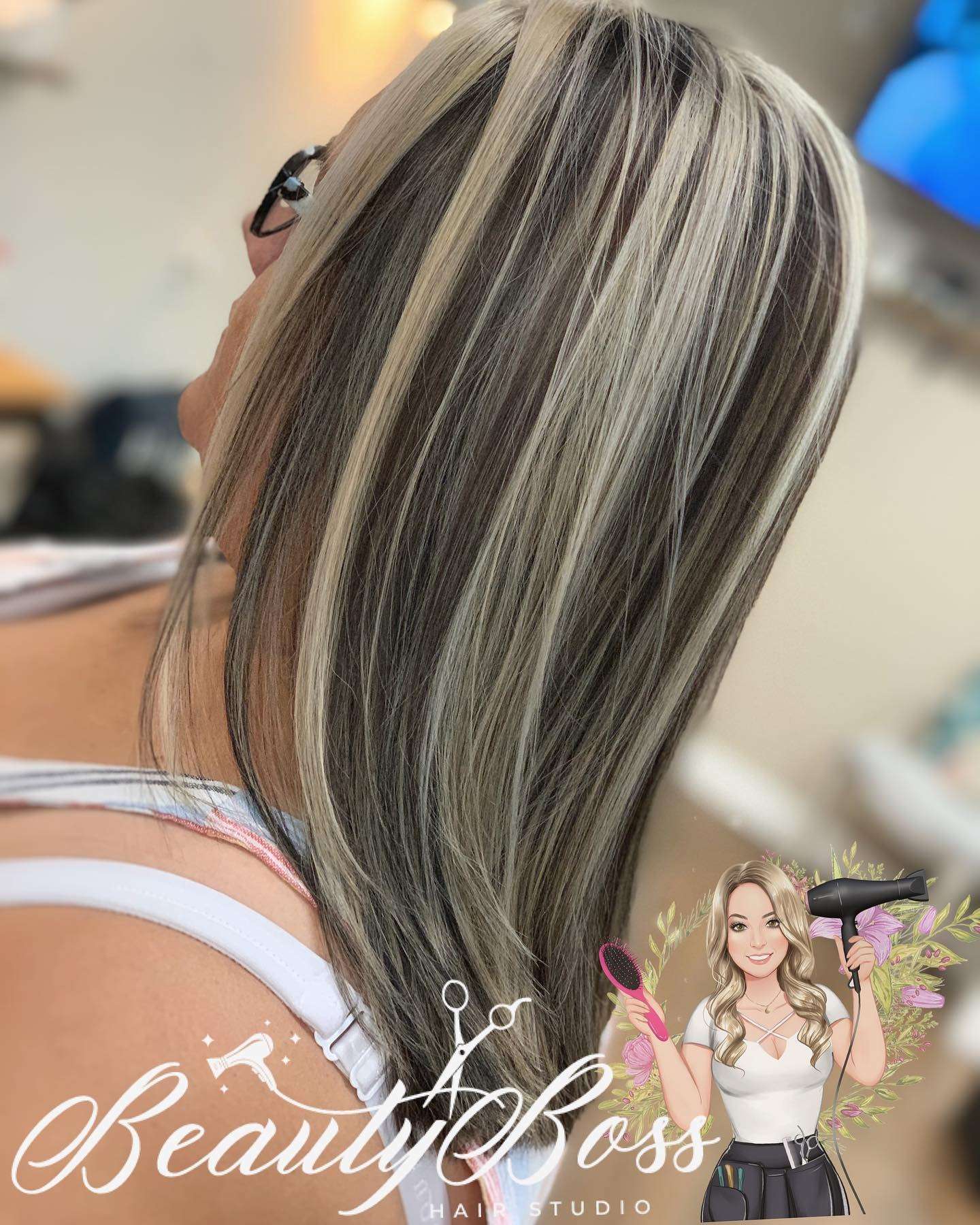 Chunky blonde highlights through dark brown hair, straight and sleek