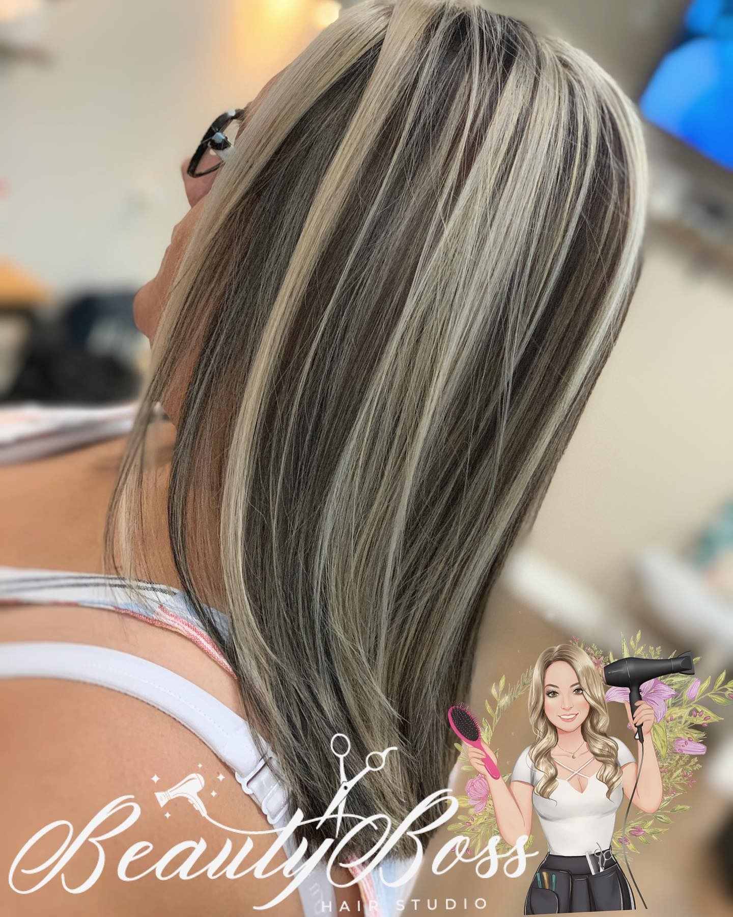 Chunky blonde highlights through dark brown hair, straight and sleek